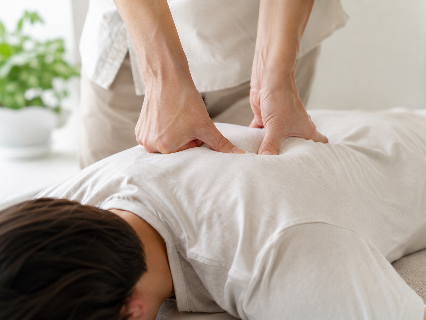 Hands applying pressure through clothing during a Meridian Massage session