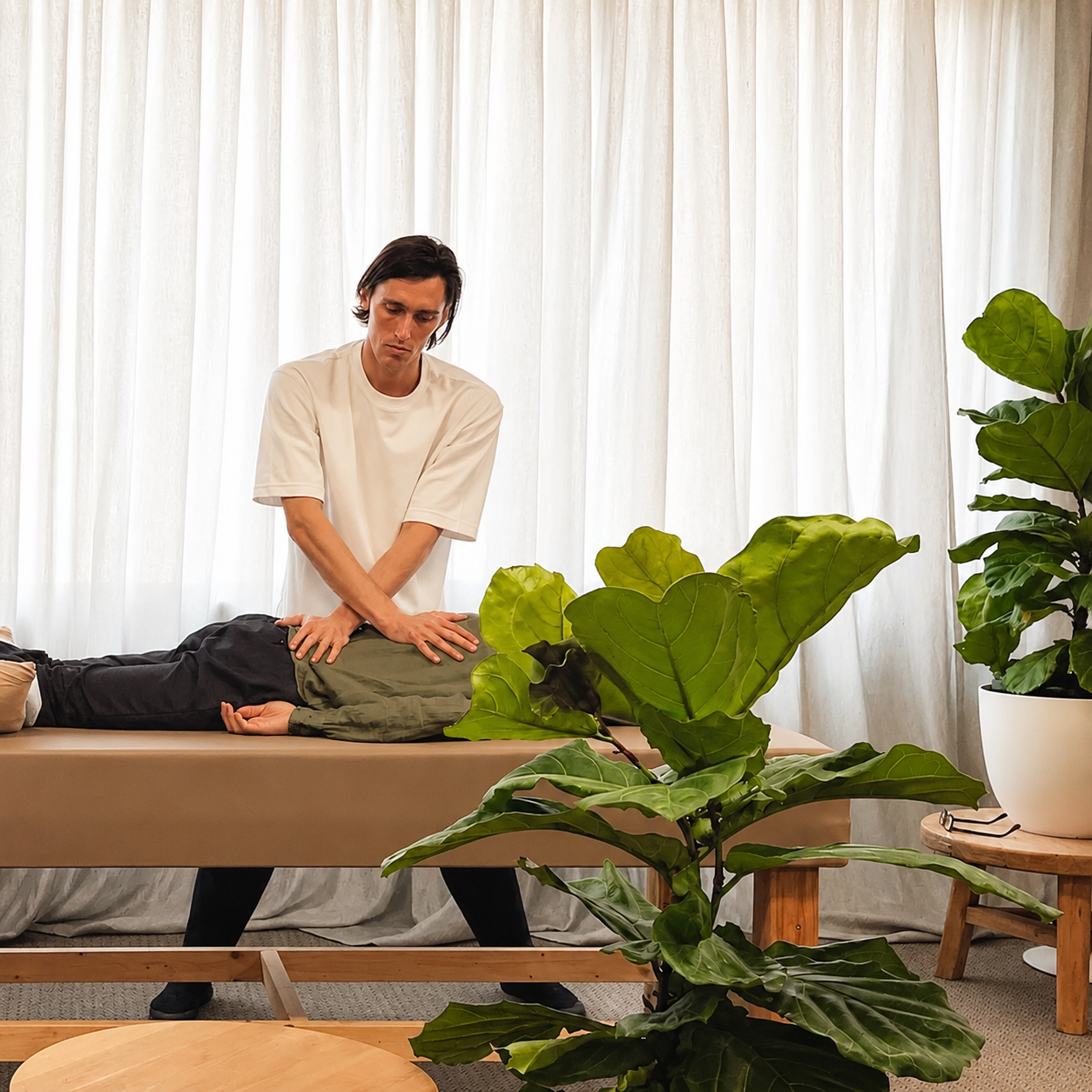 Jack Logan applying treatment during a Shiatsu and Meridian Massage session